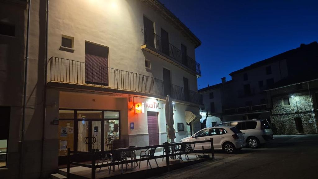 a car parked in front of a building at night at Hostal Restaurante Portell in Portell de Morella