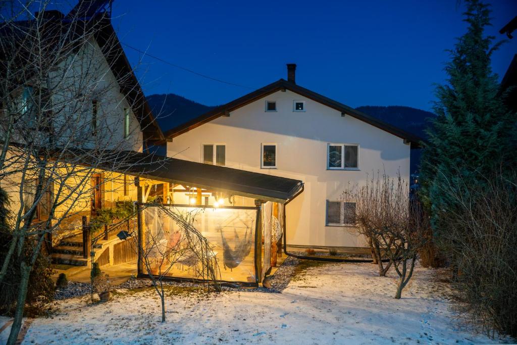a large white house in the snow at night at Casa Puiu in Câmpulung Moldovenesc