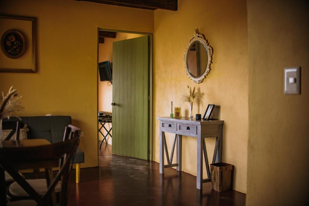 a room with a green door and a table at La Magia del Bosque in Puebla