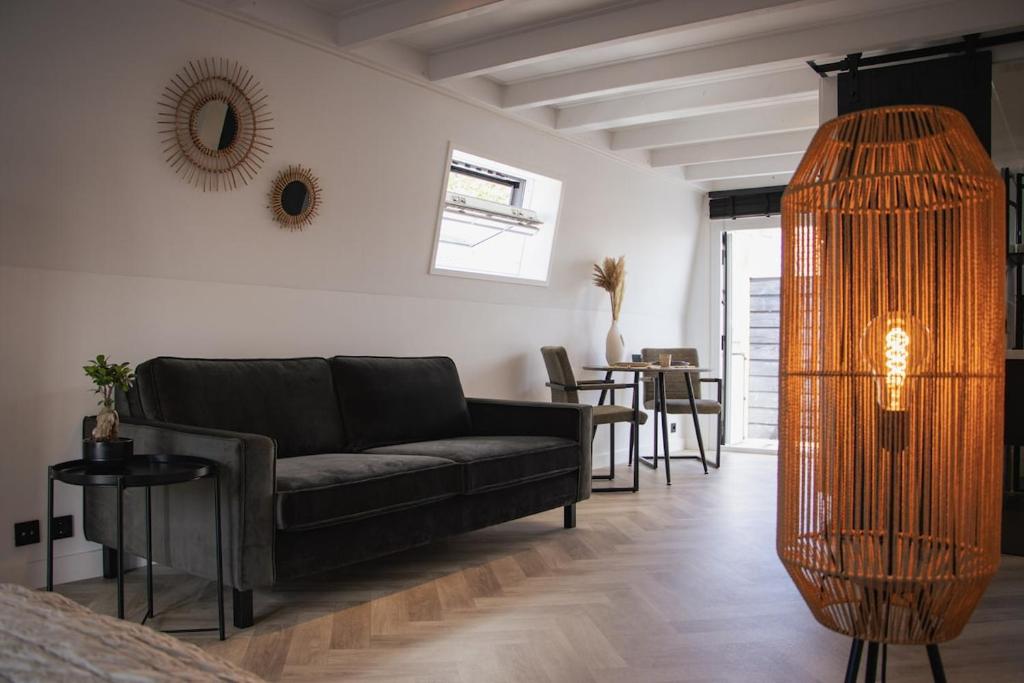 a living room with a couch and a table at Loft 15 in Alkmaar