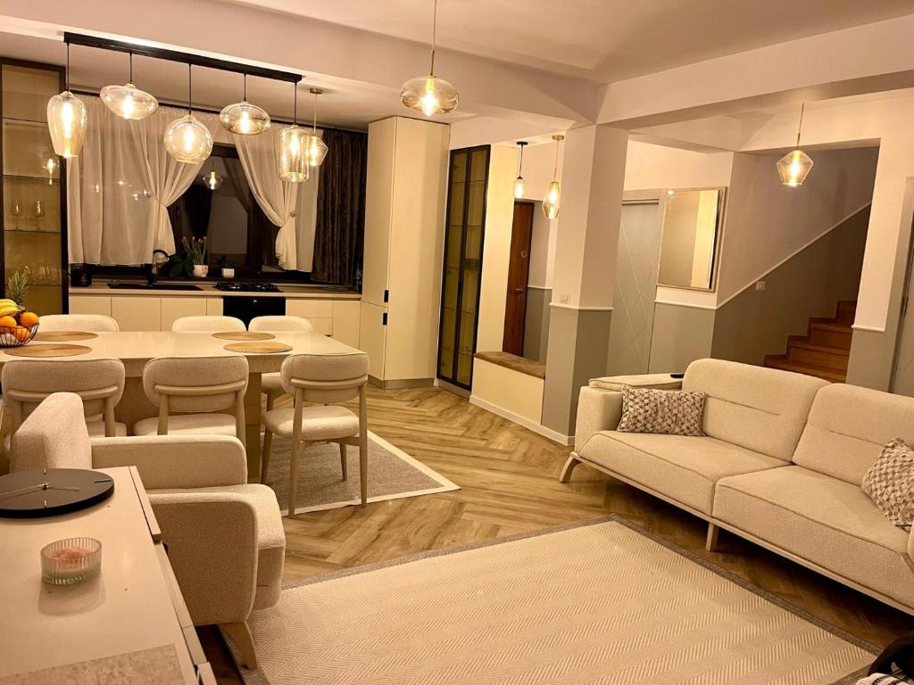 a living room with a couch and a table at Del House in Zărneşti