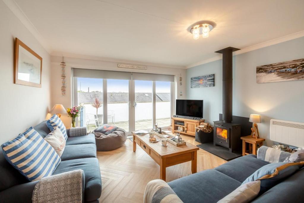a living room with a blue couch and a tv at 3 Bed in Abersoch oc-c33667 in Abersoch