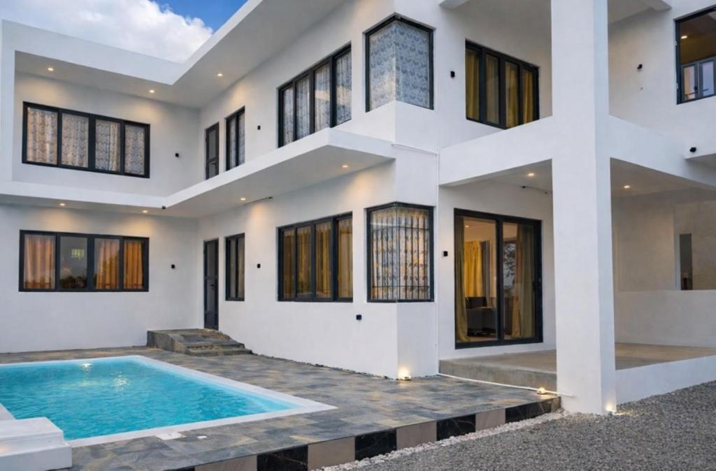 an exterior view of a house with a swimming pool at D'eaU BleU Villa-Private pool in Pereybere