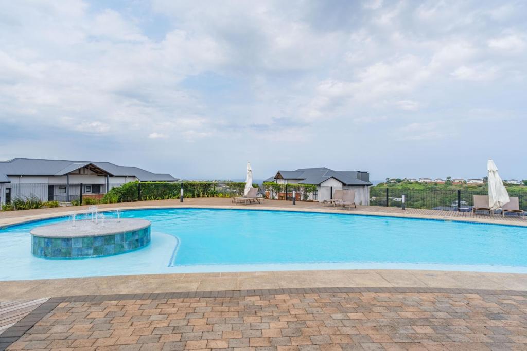 a large blue swimming pool with a fountain at Ballito Hills 830 in Ballito