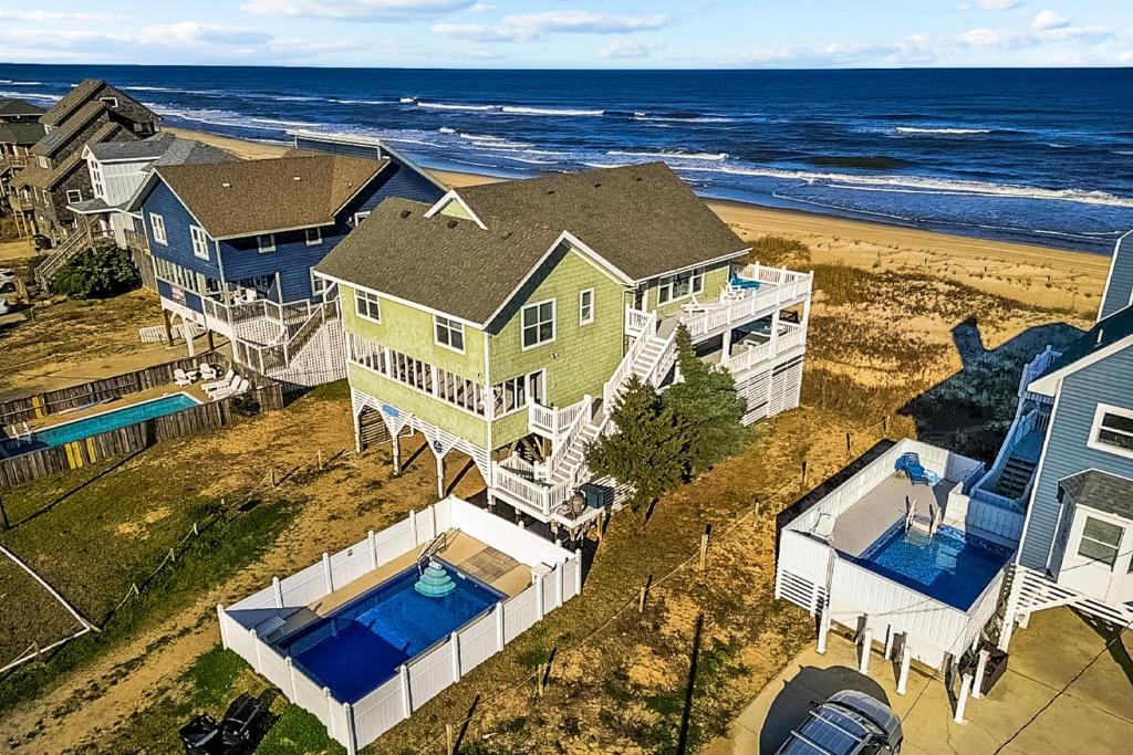 an aerial view of a house on the beach at Beachfront Villa Royale OBX in Avon