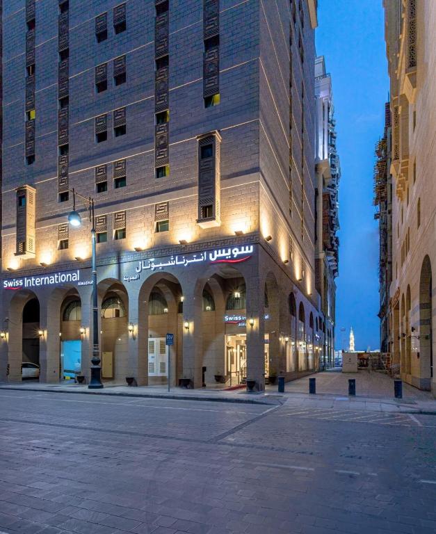 a large building with lights on the side of it at Taba Al Salam in Medina