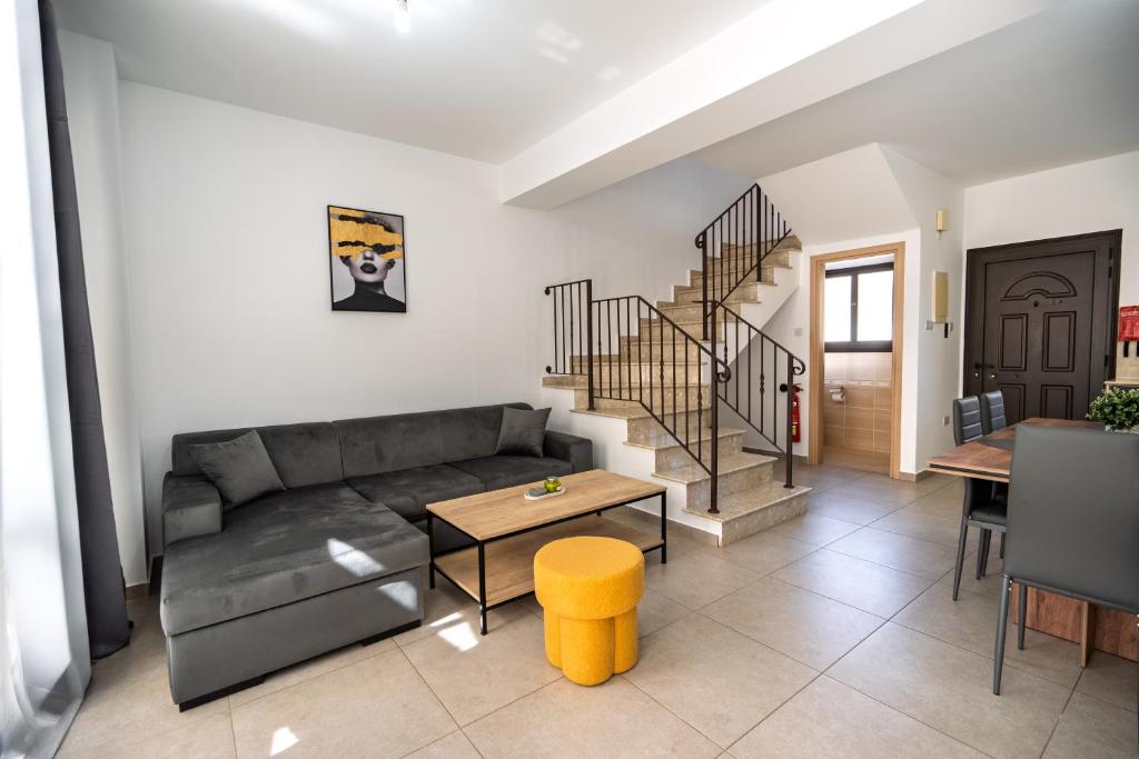 a living room with a couch and a table at Elia House In Kapparis in Paralimni