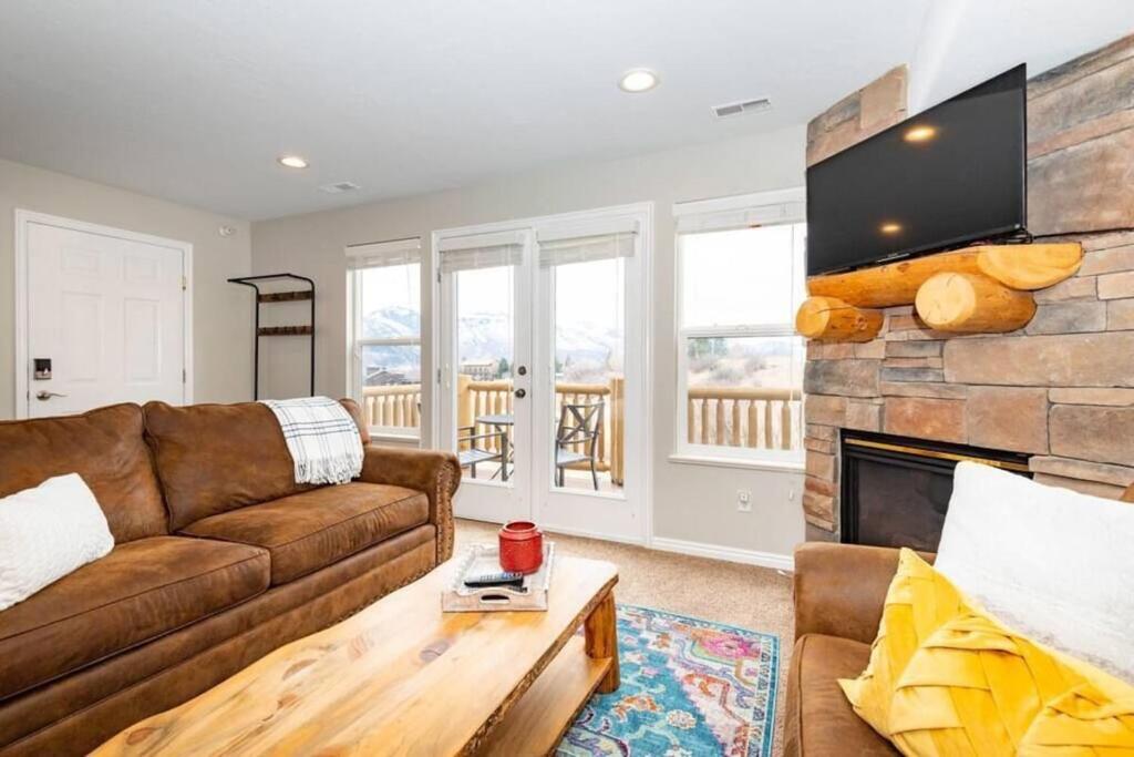 a living room with a couch and a fireplace at Powder Mtn Retreat MH110 Near Powder Mtn Hot Tub in Eden