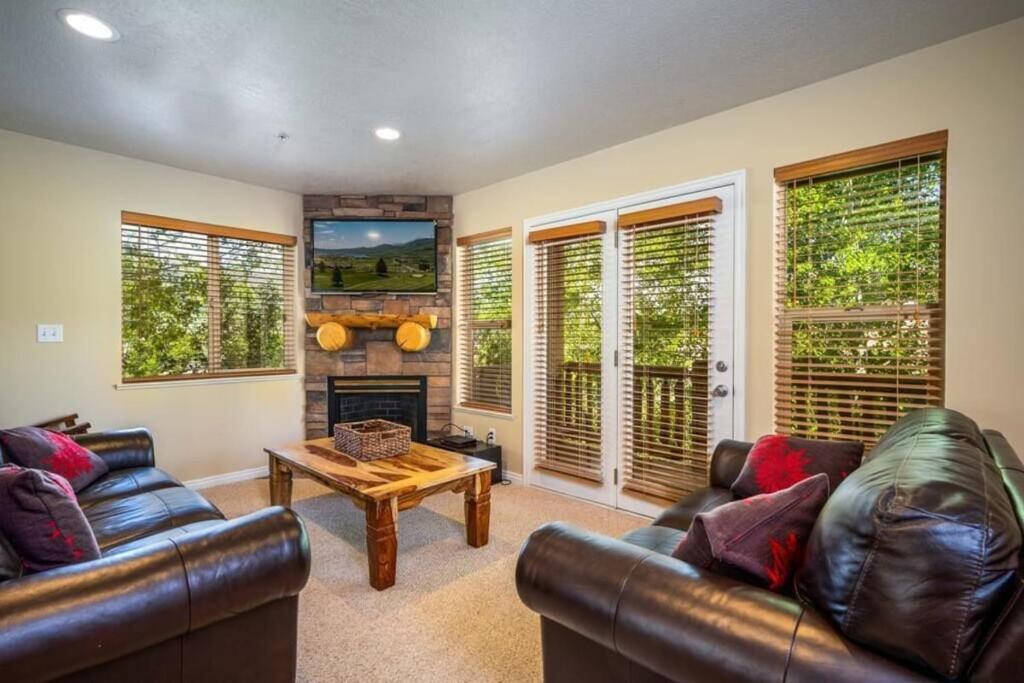 a living room with leather furniture and a fireplace at Ski Paradise MH 303 Near Powder Mtn Hot Tub in Eden
