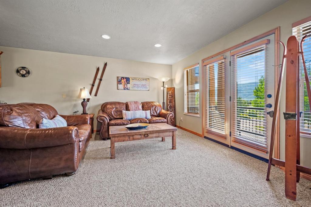 a living room with two leather couches and a table at Eden Mtn Retreat MH207 Near Powder Mtn Hot Tub in Eden