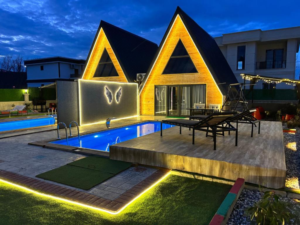 a house with a swimming pool in front of it at Atlasluxuryhome mor in Samsun