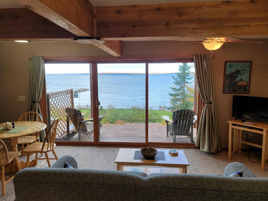 a living room with a view of the ocean at Bayfield Island View Lodging, Bayfield, WI in Bayfield