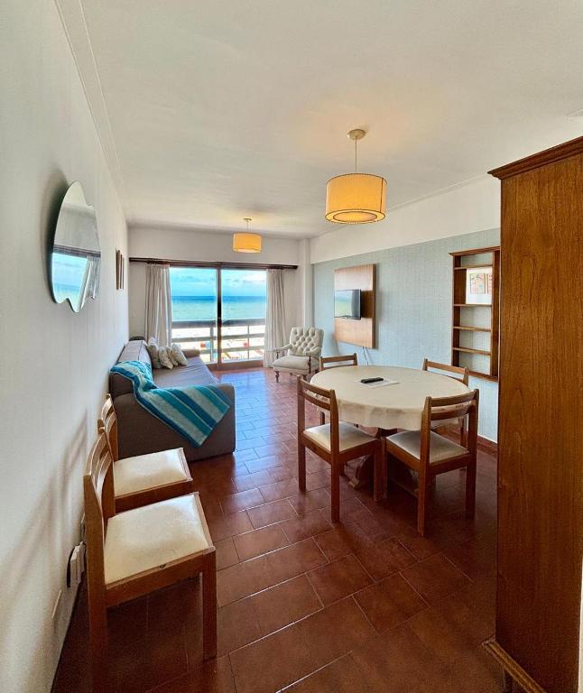 a living room with a couch and a table at Depto Frente Al Mar, Edificio Iskofema II in Miramar