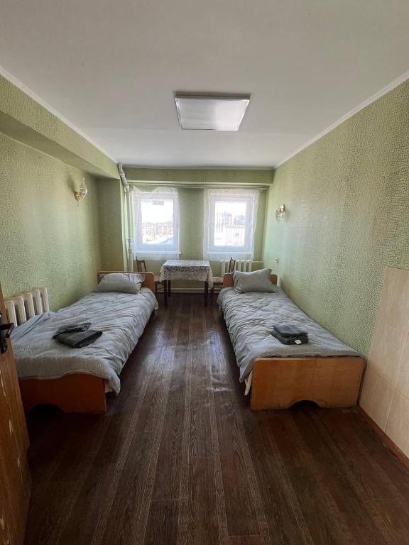 a room with two beds in a room at Готель Оаsa in Lutsk