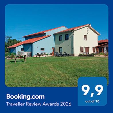 a picture of a house with a sign that says travel review awards at Apartamentos Casa Reconco in Luanco