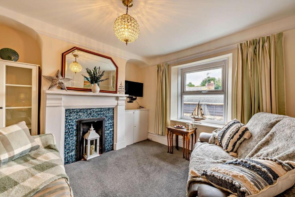 a living room with a couch and a fireplace at 2 Bed in Appledore oc-s29561 in Appledore