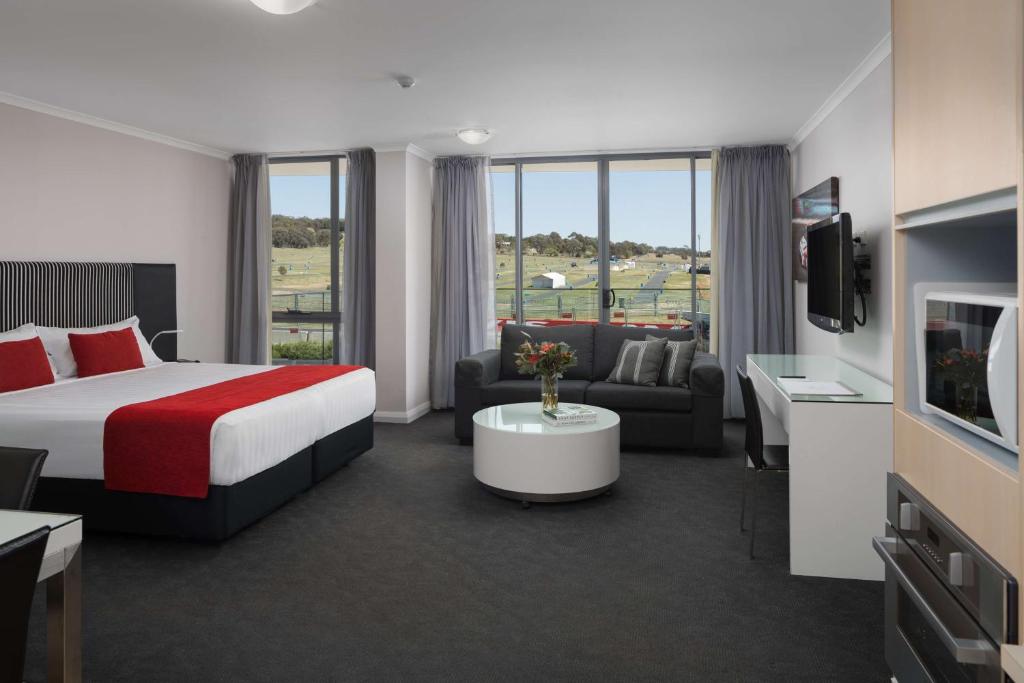 a hotel room with a bed and a tv at Rydges Mount Panorama Bathurst in Bathurst