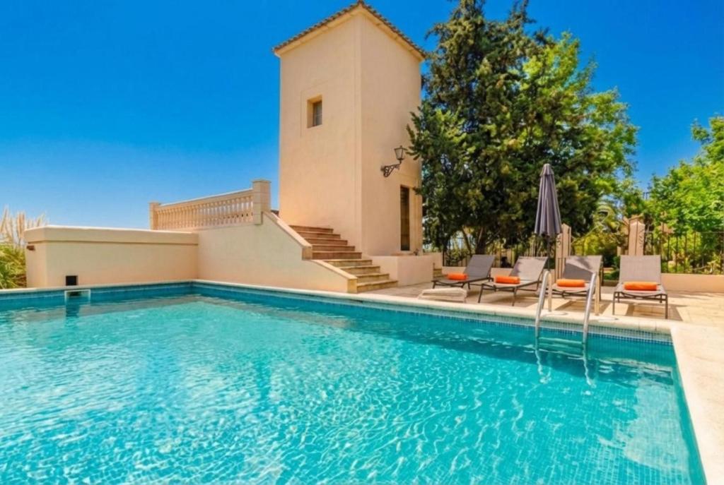 a villa with a swimming pool and a house at Sort Nova in Montuiri