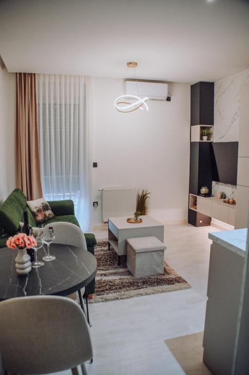 a living room with a couch and a table at Lumina Residence Našice in Našice