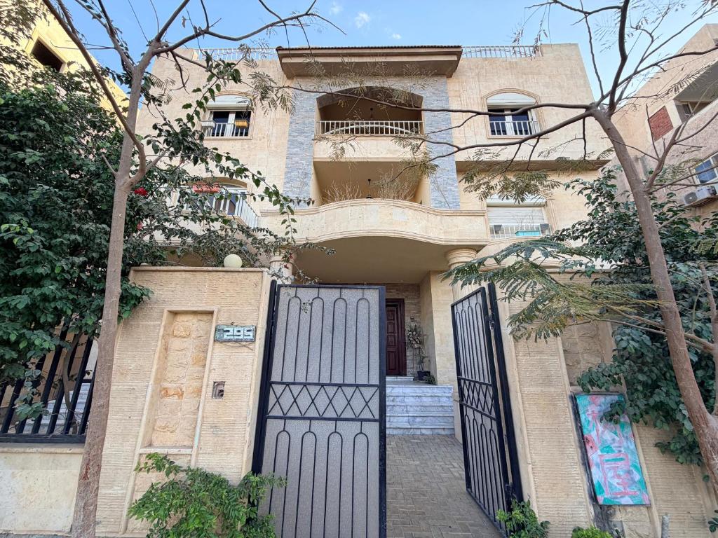 a house with a gate in front of it at 树屋民宿 in Cairo
