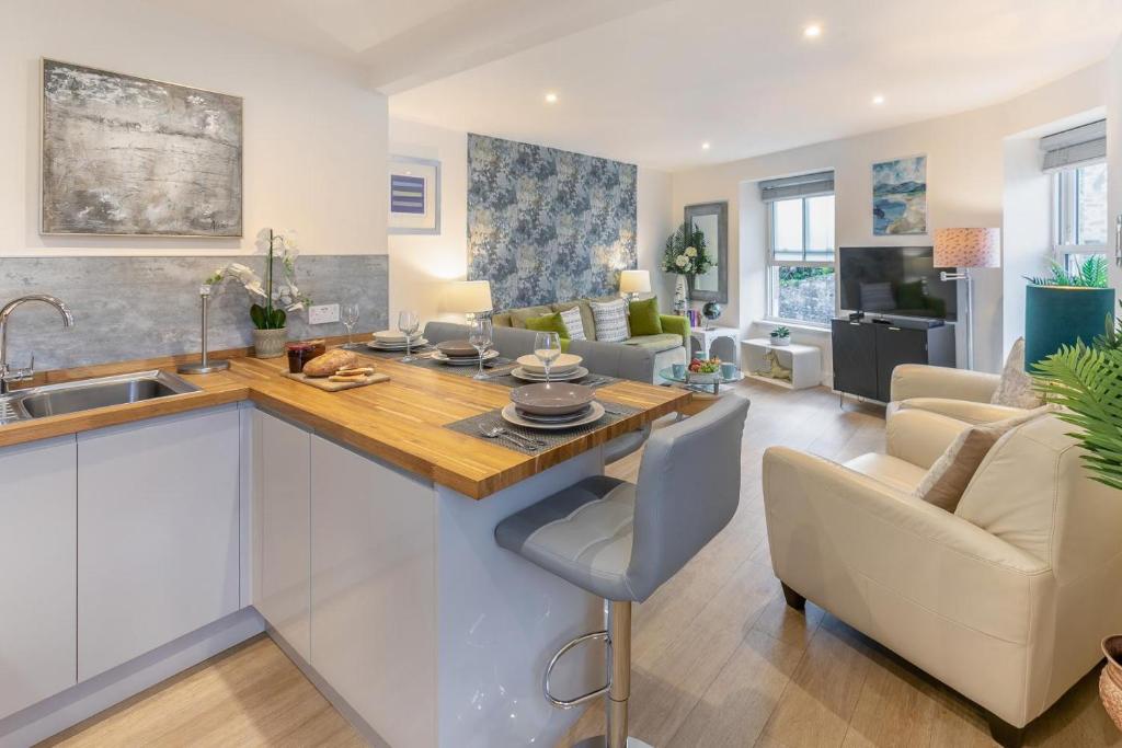 a kitchen and living room with a sink and a counter at 2 Bed in Penzance oc-u34133 in Penzance