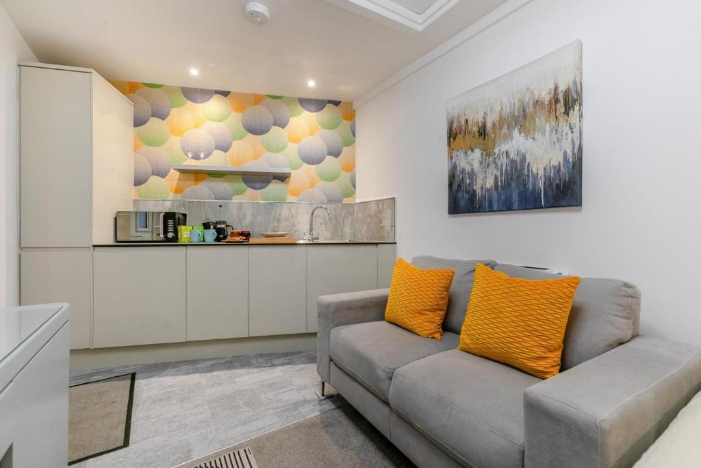 a living room with a couch and a kitchen at 1 Bed in Penzance oc-u34132 in Penzance