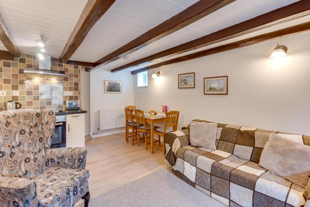 a living room with a couch and a table at 3 Bed in Whitby oc-w009 in Whitby