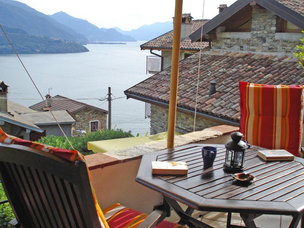 a table on a balcony with a view of a lake at Asti in Gravedona