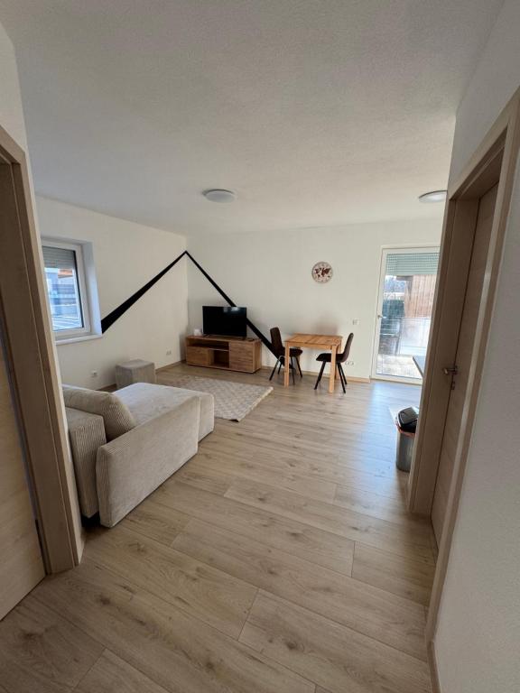 a living room with a couch and a table at Loft05 in Wankham
