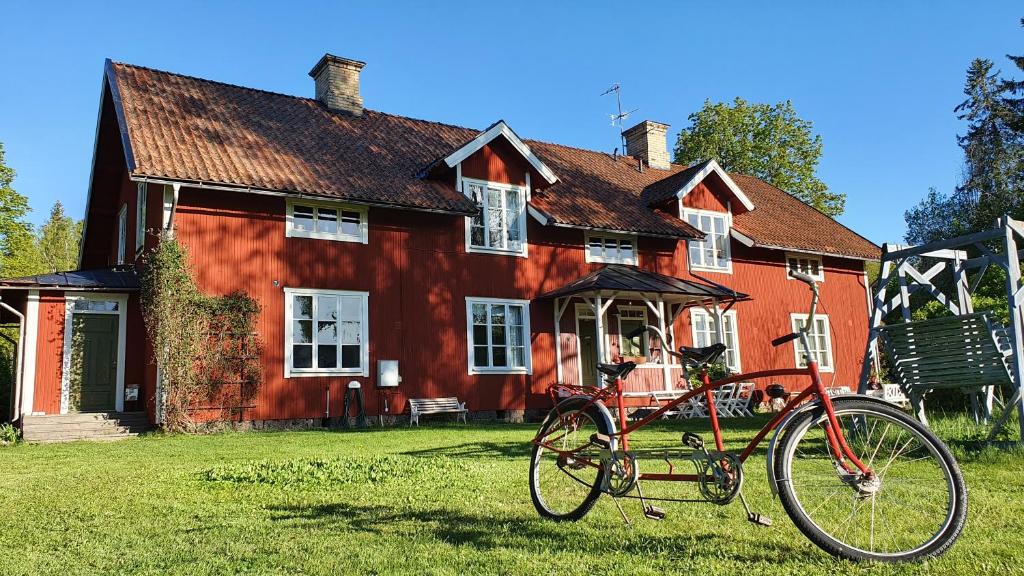 a bike parked in front of a red house at Lägenhet Strömsberg C in Strömsberg