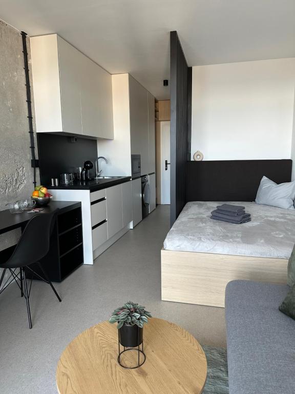 a large room with a bed and a kitchen at Apartment Kysucká 1014 Top Floor & View in Košice