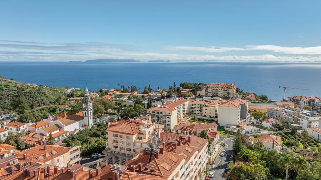 an aerial view of a town next to the water at BoLina Caniço Center in Caniço
