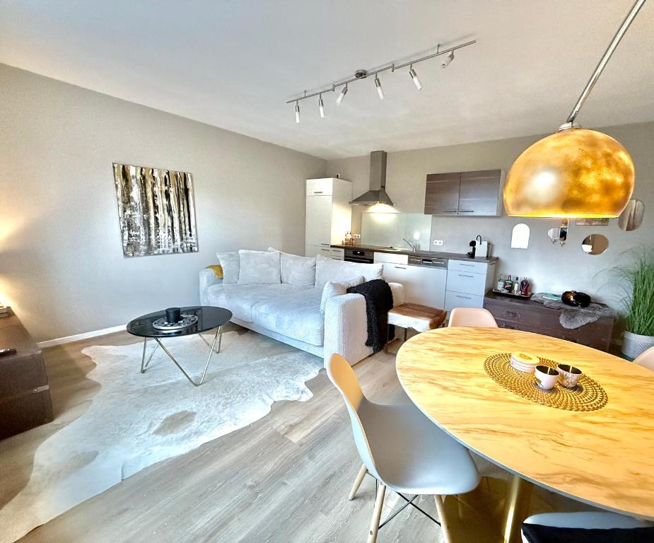 a living room with a couch and a table at Das Haus am Weinberg in Ensch