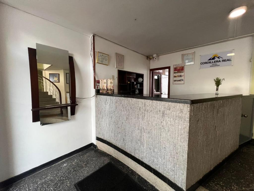 a restaurant with a counter in a room at Hotel Cordillera Real in Sogamoso