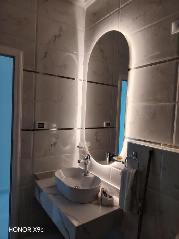 a bathroom with a sink and a mirror at SunShine in Quseir