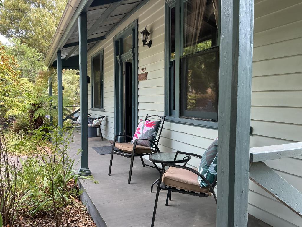 a porch of a house with chairs and a table at Bromwich Guest House - 250m to town centre! in Blackwood