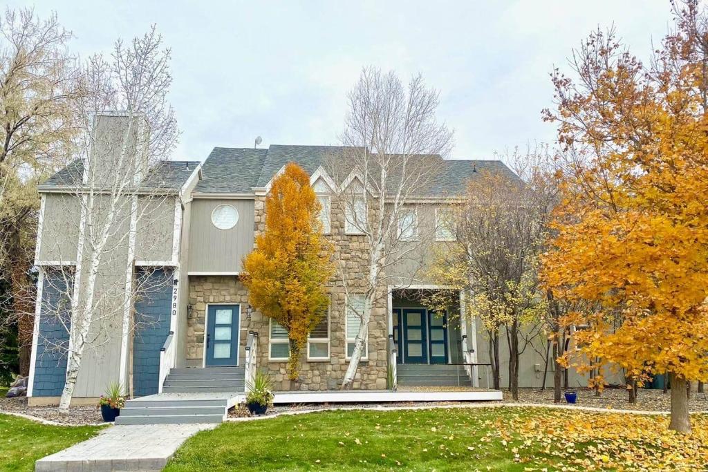 a large house with a yard with trees at Lehi East Bench Private Studio! in Lehi