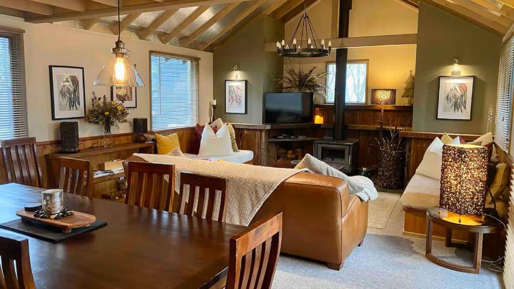 a living room with a couch and a table at Highlander in Dinner Plain