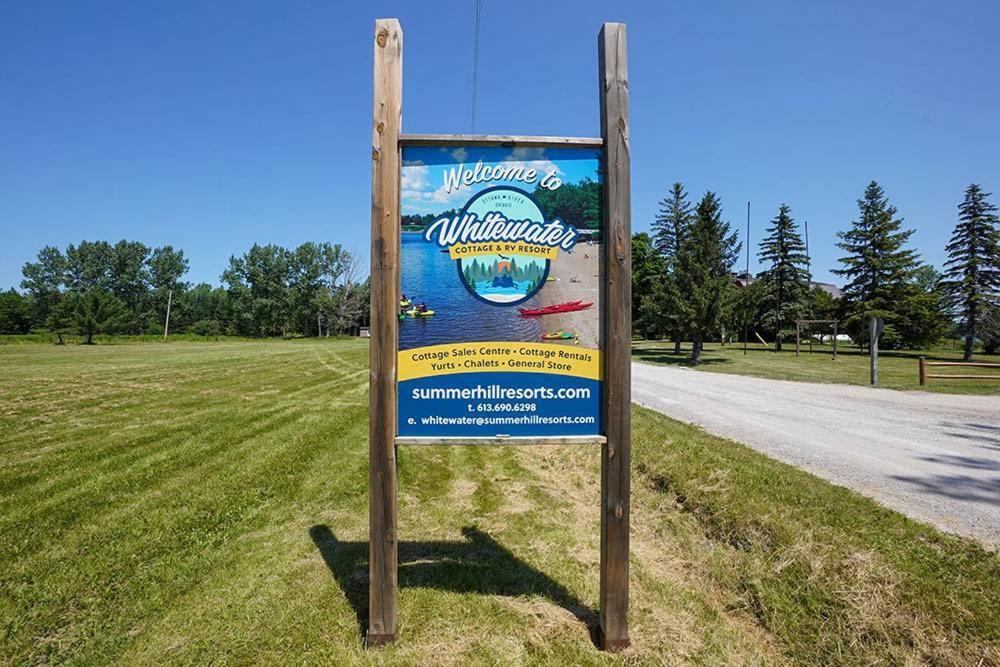 a sign on the side of a road at Whitewater Cottage & RV Resort in Foresters Falls