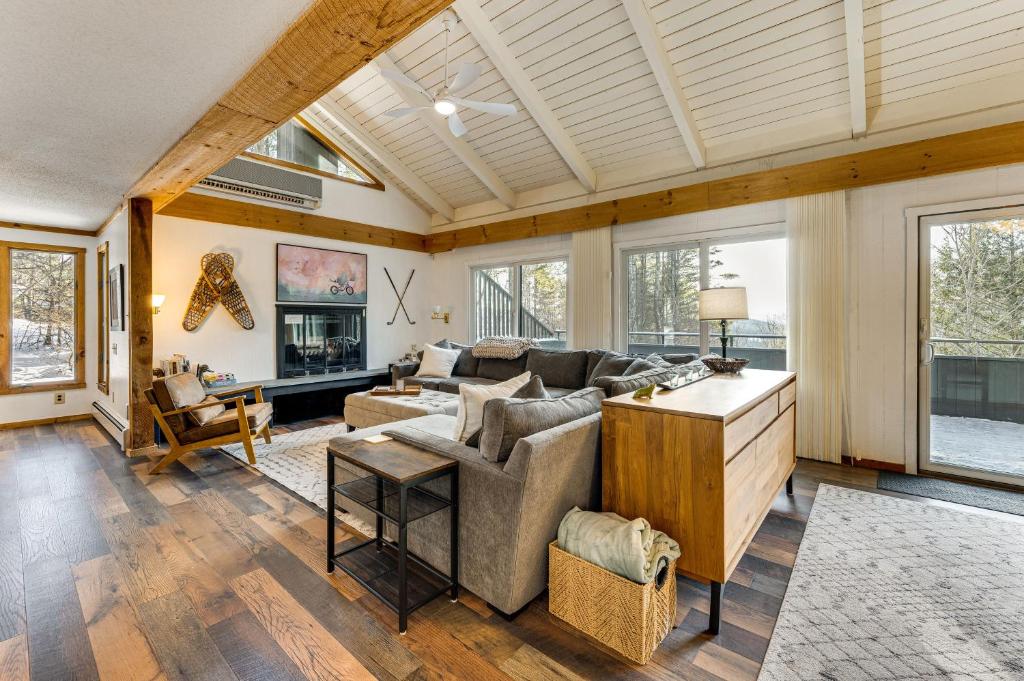 a living room with a couch and a table at Resort-Style Community! Quechee Chalet w/ Deck in Quechee