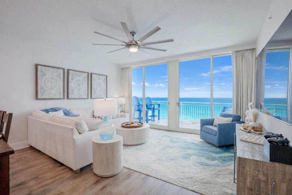 a living room with a view of the ocean at Ocean Blue at 1805 Aqua in Panama City Beach