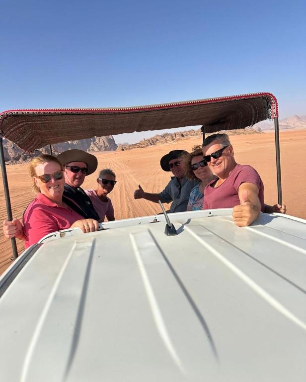 a group of people in a jeep in the desert at Jeep trips in the desert in Wadi Rum