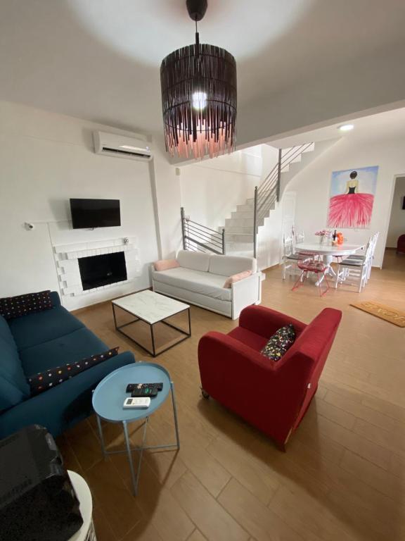 a living room with a couch and a table at My Olive Tree House in Kalamata
