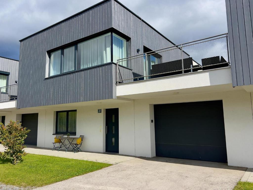 a house with a balcony on top of it at Winzerchalet in Sankt Lambrecht