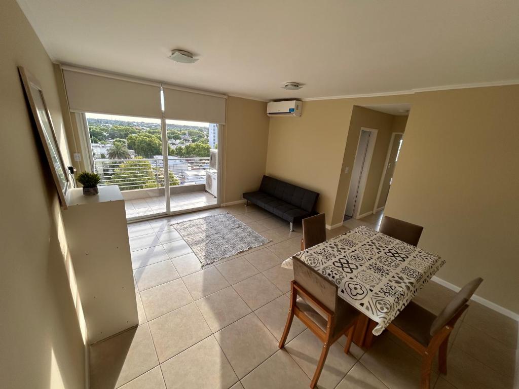 a living room with a table and a couch at Portal del Sol in Junín