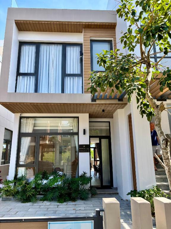 aominium building with a facade of white at Aurora Golf Villa in Bình Sum