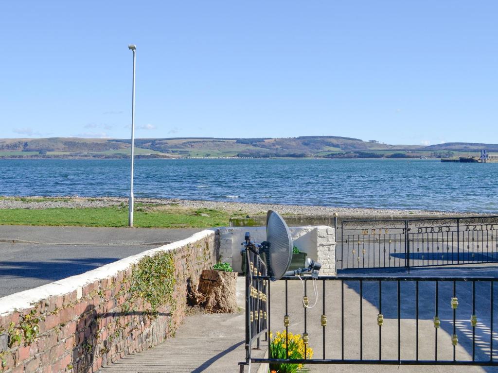 a view of a body of water with a fence at Ailsa Craig View in Stranraer