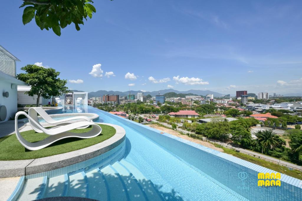 a hotel swimming pool with a view of the city at Stallionz by Mana Mana in Ipoh