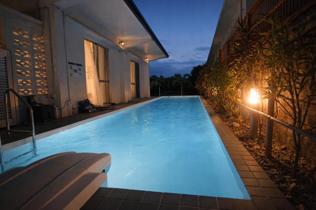 a large swimming pool in a building at night at Machinaka Miyako in Miyako-jima