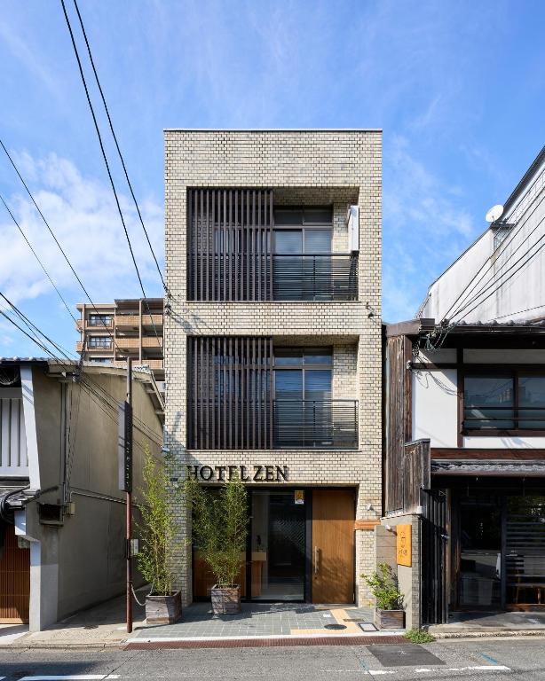 a brick building with a hotel sign on it at Hotel Zen in Kyoto